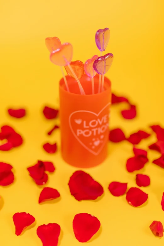 a vase filled with lots of red rose petals, by Julia Pishtar, pop art, glow sticks, orange pastel colors, made of candy and lollypops, love hate love