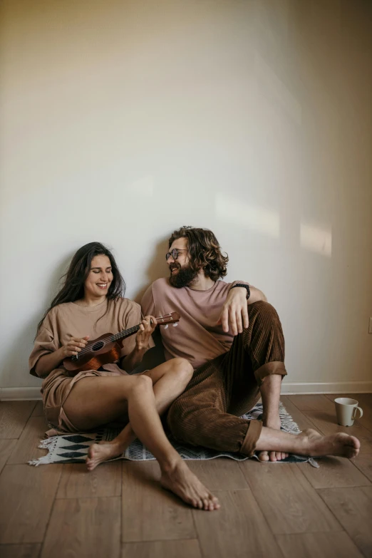 a man and a woman are sitting on the floor, pexels contest winner, cottagecore hippie, ukulele, but minimalist, flirting