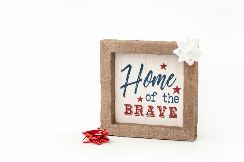 a picture frame with the words home of the brave on it, a picture, square, white bg, background image, star born
