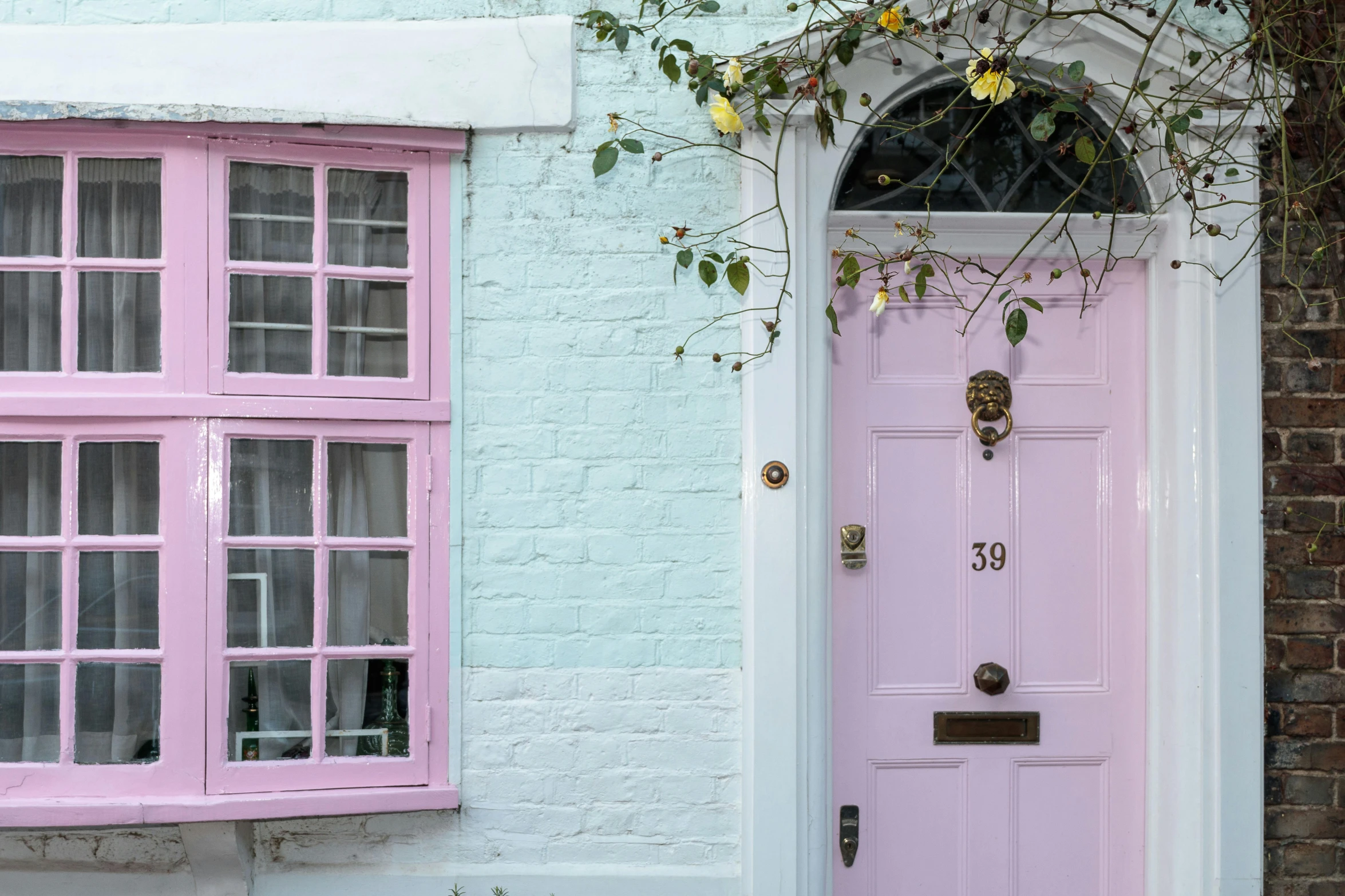 a pink door in front of a white brick building, pexels contest winner, arts and crafts movement, bay window, purple, pink, aquamarine windows