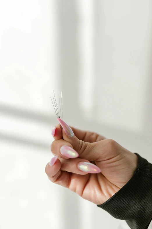 a close up of a person holding a toothbrush, ultra detailed wire decoration, long nails, ready to model, translucent gills