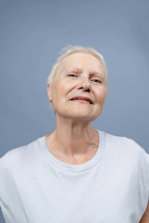 a close up of a person with a tooth brush, with short bobbed white hair, confident relaxed pose, wearing a t-shirt, double chin