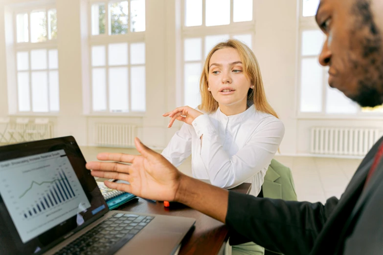 a man and a woman sitting in front of a laptop computer, pexels, with pointing finger, wearing a white blouse, avatar image, professional image