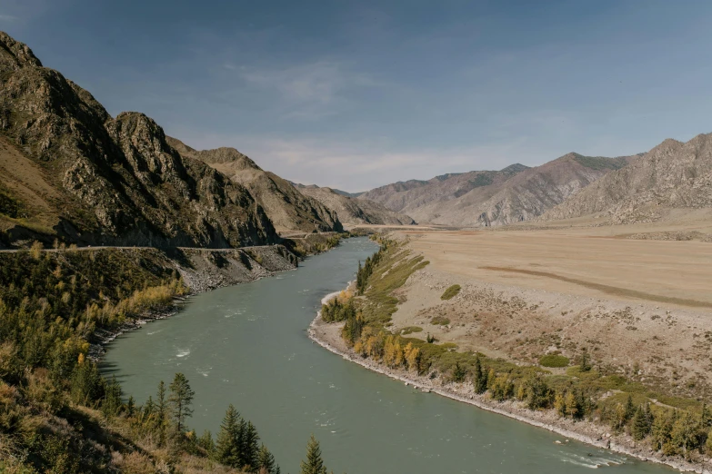 a river running through a lush green valley, by Muggur, pexels contest winner, hurufiyya, kazakh empress, gravel and scree ground, shot on hasselblad, autum