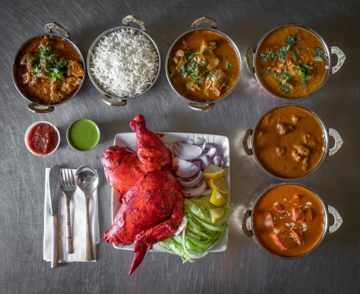 a table topped with lots of different types of food, six arms, kali, bowl filled with food, lobster