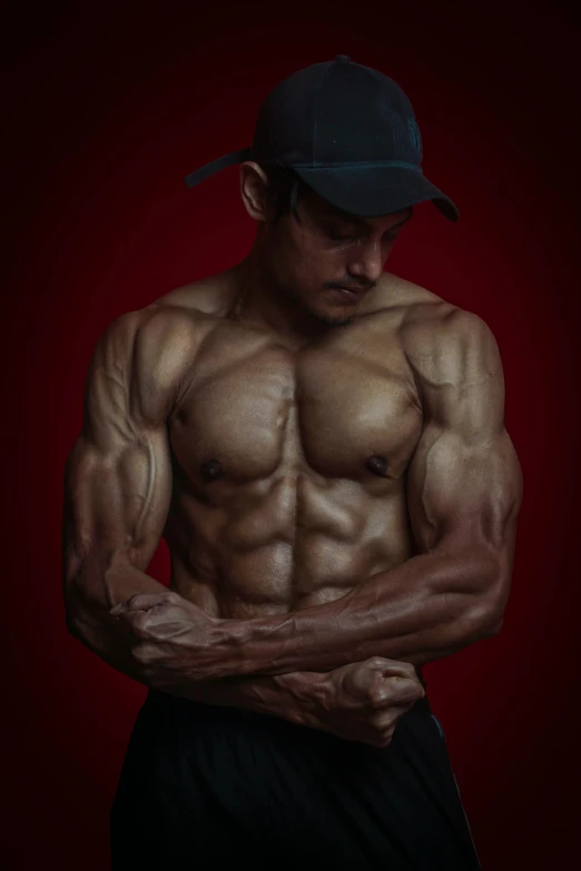 a man flexing his muscles on a red background, a colorized photo, inspired by Rudy Siswanto, hyperrealism, ernest khalimov body, alessio albi, indian, muscular! fantasy