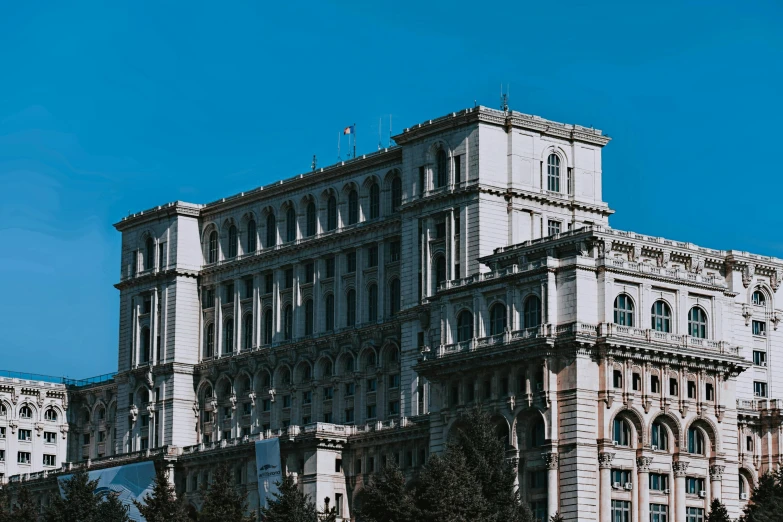 a large building with a clock on top of it, pexels contest winner, socialist realism, buildings covered with greebles, romanian heritage, background image, the building is a skyscraper