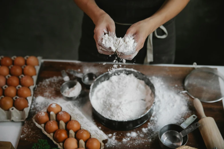 a woman sprinkles flour into a bowl of eggs, a portrait, trending on pexels, fan favorite, chef table, baking cookies, gardening