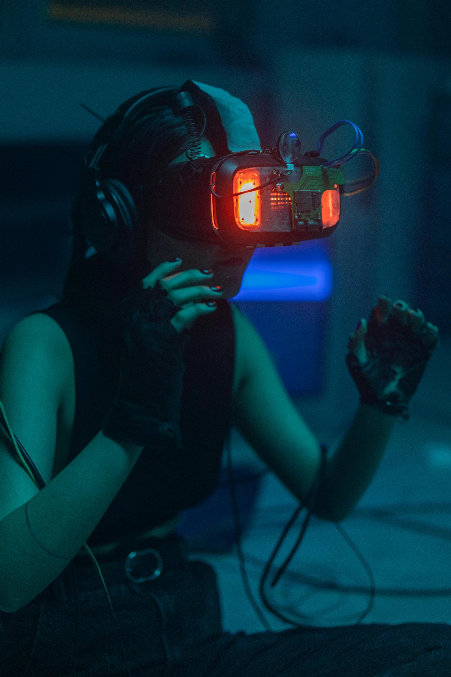 a woman using a virtual reality device in a dark room, cyberpunk art, unsplash contest winner, wearing a gaming headset, siggraph, hazy, scene from a rave
