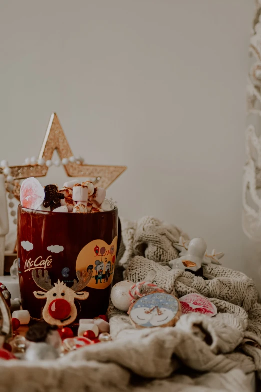 a pile of stuff sitting on top of a table, by Julia Pishtar, pexels contest winner, decorated ornaments, with a cup of hot chocolate, profile image, kids