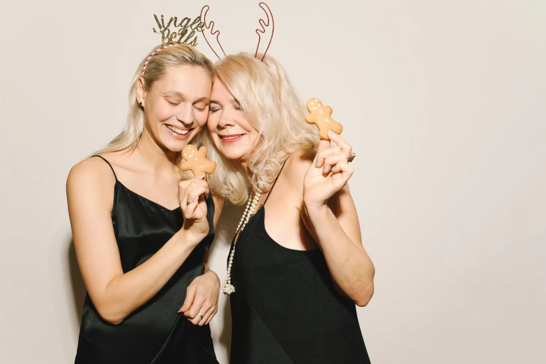 a couple of women standing next to each other, pexels, happening, new years eve, a blond, photo booth, gingerbread people