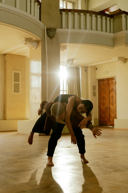 a couple of people that are standing in a room, by Nina Hamnett, arabesque, breakdancing, day light, square, b - roll