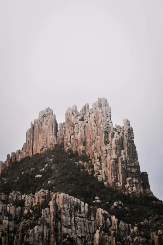 a mountain that has some very tall rocks on it, unsplash contest winner, baroque, manly, exterior, slight overcast, spires