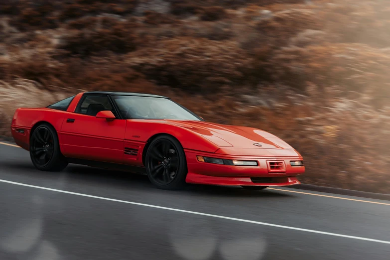 a red sports car driving down the road, a portrait, by Jeffrey Smith, knight rider, restomod, 90s photo, ultra high res