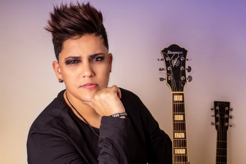 a close up of a person with a guitar, an album cover, inspired by Randy Vargas, androgynous male, profile image, commercial photo, mohawk