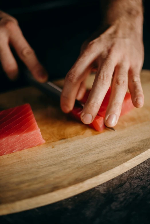 a person cutting up a piece of watermelon on a cutting board, ukiyo, detailing, no - text no - logo, sushi
