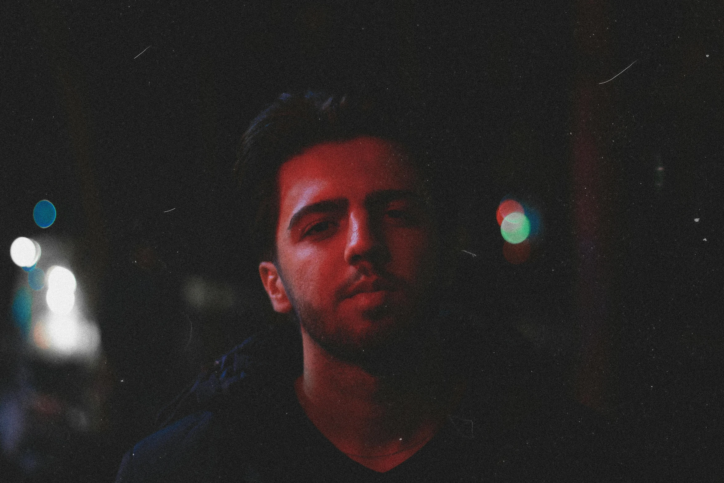 a man standing in the dark with his eyes closed, an album cover, inspired by Elsa Bleda, pexels contest winner, hurufiyya, low quality grainy, sam nassour, looking directly at the camera, zaha hadi