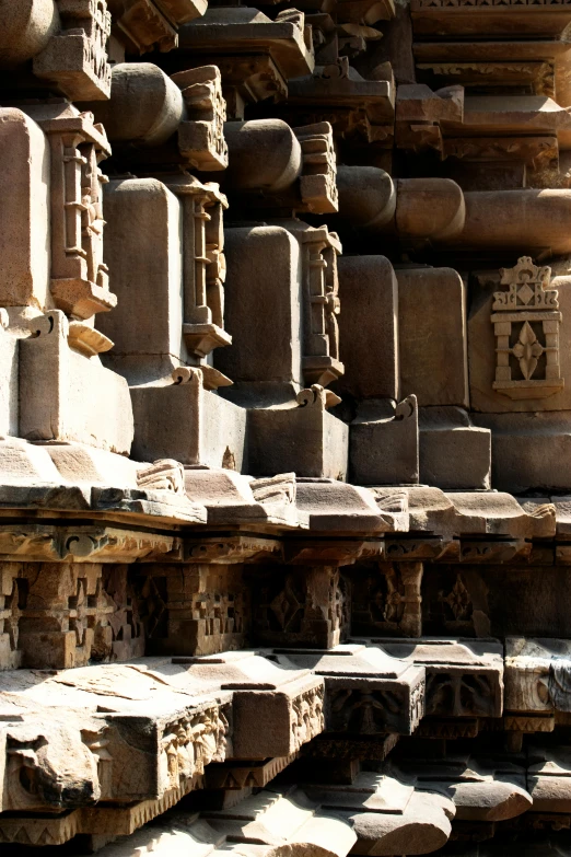 a man standing in front of a stone structure, epic khajuraho, greeble detail, sitting on temple stairs, award - winning art