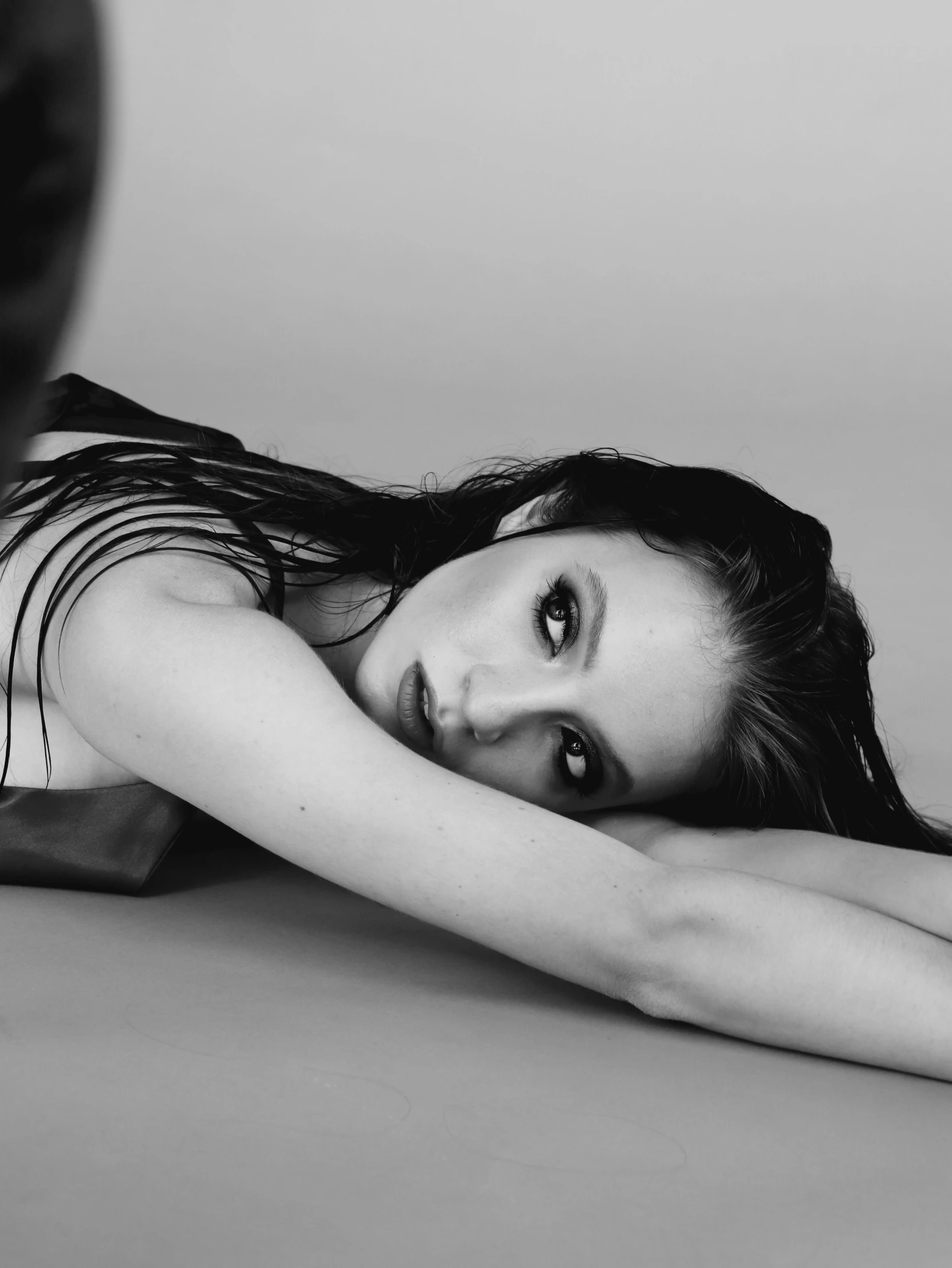 a black and white photo of a woman laying on the floor, inspired by Elizabeth Polunin, born this way album, lowres, promotional image, emmy rossum