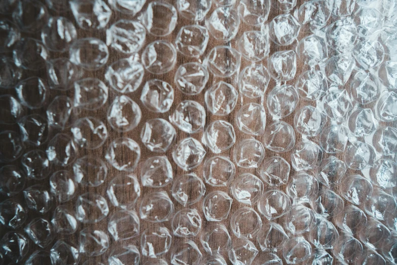 a close up of a piece of glass on a table, by Nina Hamnett, unsplash, hyperrealism, fish skin, wood materials, bubble background, repeating pattern