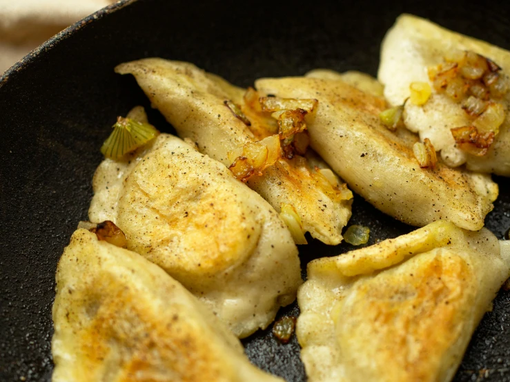a close up of a frying pan filled with food, dumplings on a plate, citrinitas, thumbnail, fan favorite