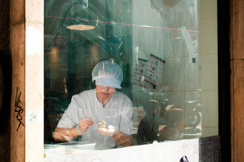 a man that is sitting in front of a window, wearing white chef hat, shopwindows, hatching, foil