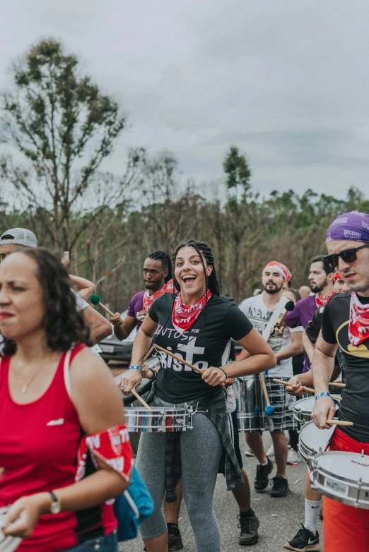 a group of people that are standing in the street, playing drums, puerto rico, smiling spartan, party in jungles