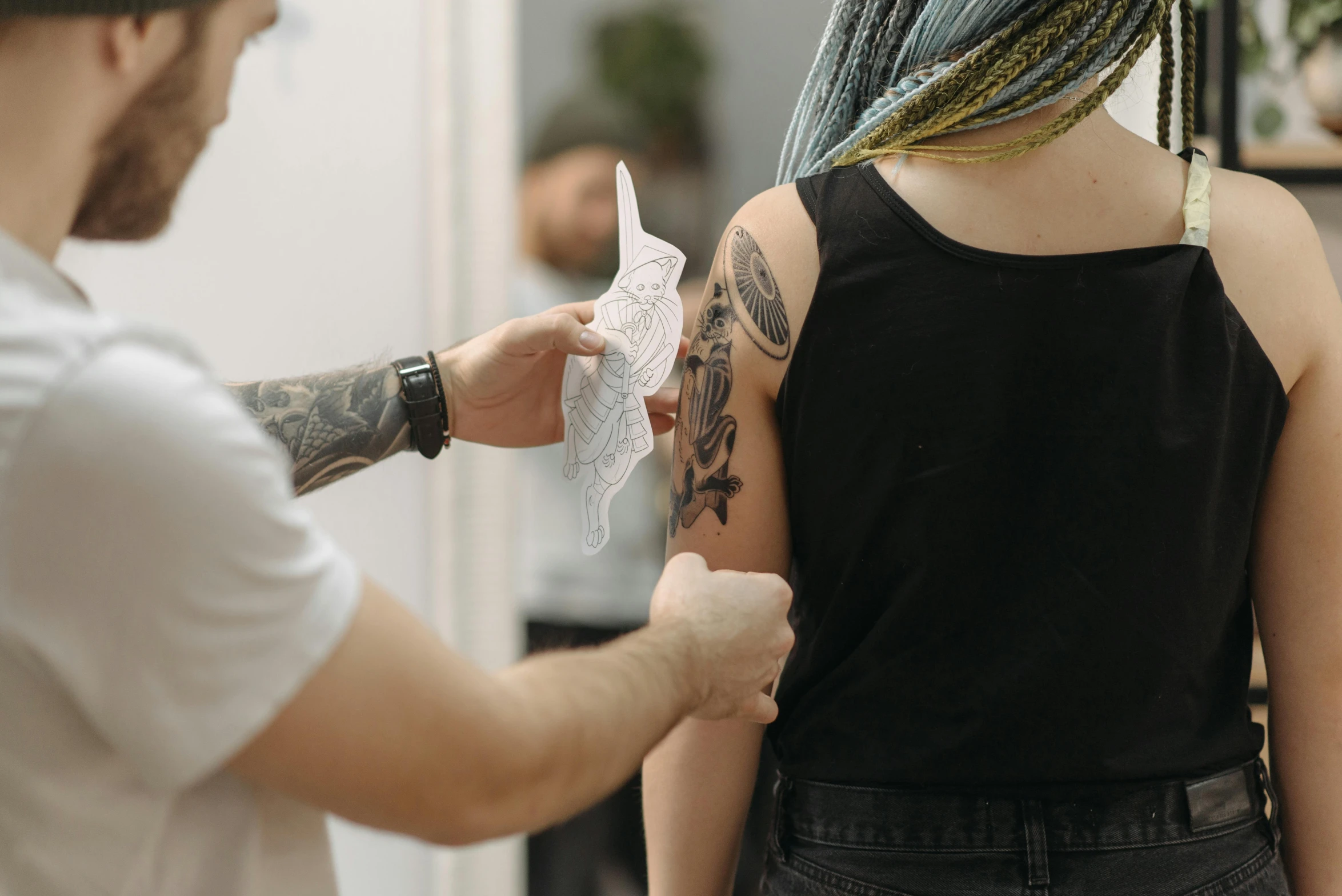 a man getting a tattoo on a woman's back, pexels contest winner, tribal tattoos right arm sleeve, profile image, stick and poke, physical painting