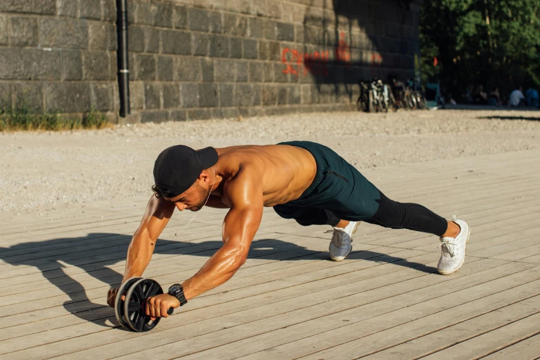 a man doing push ups on a wooden floor, a photo, by Julia Pishtar, hurufiyya, wheel, with abs, hypersphere, hammershøi