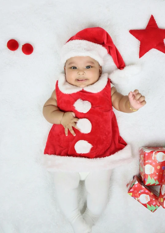 a baby wearing a santa claus outfit next to a christmas present, shutterstock contest winner, happening, sleeveless red dress, nivanh chanthara, full body shot 4k, square