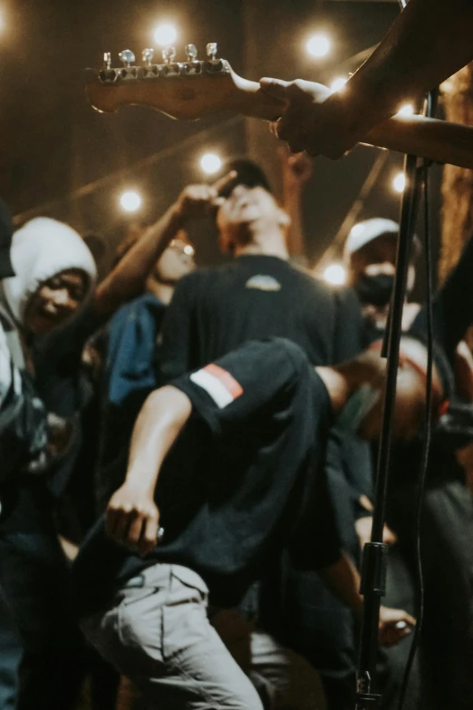 a group of men standing next to each other on a stage, an album cover, by Basuki Abdullah, trending on unsplash, happening, scene from a rave, indonesia, rap scene, close up portrait shot