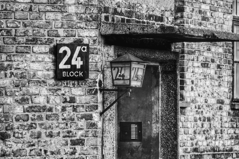 a black and white photo of a brick building, by Kristian Zahrtmann, pexels, old signs, year 2447, with a square, 27