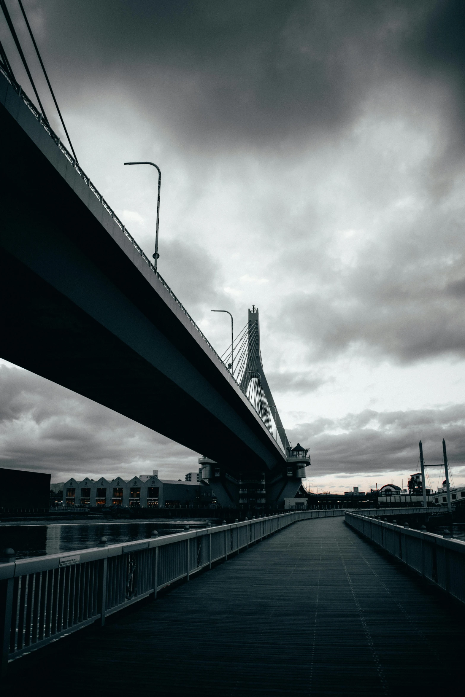 a black and white photo of a bridge, a black and white photo, unsplash contest winner, hypermodernism, boston, dark clouds in the distance, desaturated color, from street level