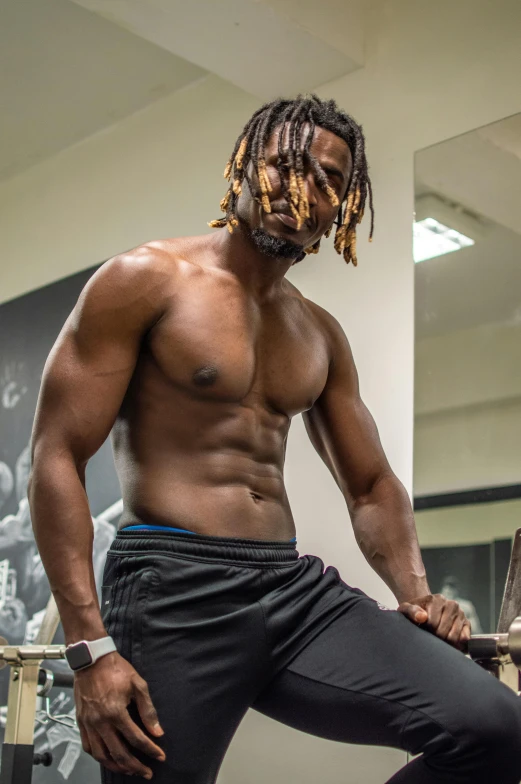 a man with dreadlocks standing in front of a mirror, inspired by Terrell James, trending on pexels, crop shirt and strong abs, local gym, shirtless :: high detail, lil uzi vert