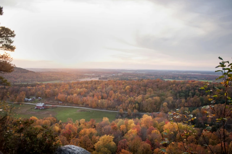 a view of a valley from the top of a mountain, by Dan Frazier, unsplash contest winner, hudson river school, muted fall colors, bentonville arkansas, lookout tower, slide show