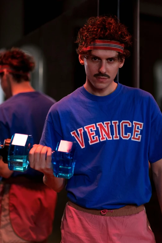 a man standing in front of a mirror holding a bottle of water, inspired by David LaChapelle, trending on reddit, renaissance, red and blue garments, venice, working out, ( ( theatrical ) )