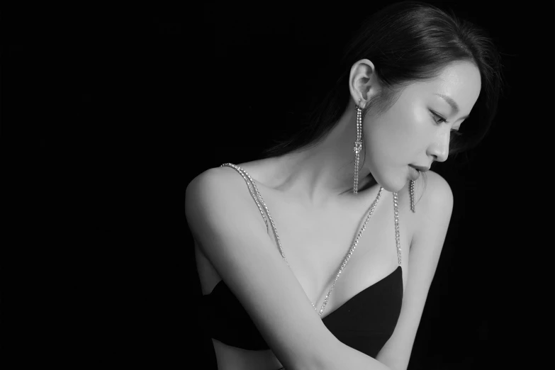 a black and white photo of a woman in a dress, minimalism, intricate led jewellery, jaeyeon nam, posing in bra, chain