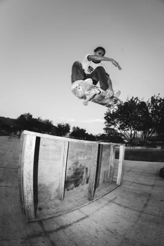 a man flying through the air while riding a skateboard, a black and white photo, square nose, structure : kyle lambert, parks, carving