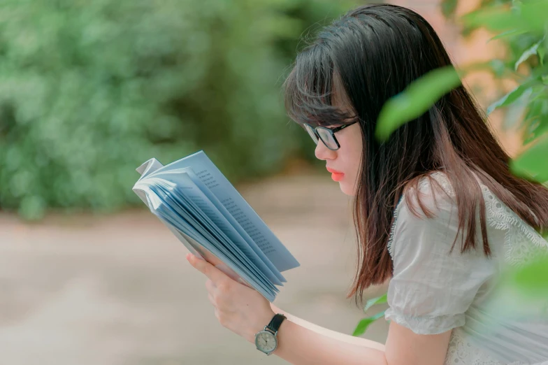 a woman sitting on a bench reading a book, pexels contest winner, realism, asian girl with long hair, profile image, wearing reading glasses, avatar image