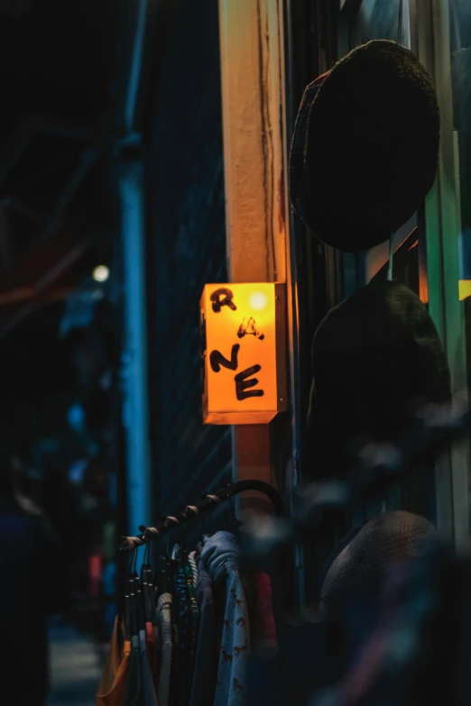 a yellow street sign sitting on the side of a building, a picture, trending on pexels, renaissance, dimly lit dive bar, tea drinking and paper lanterns, ayne haag, at a rave