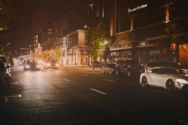 a city street filled with lots of traffic at night, by Matt Cavotta, unsplash contest winner, realism, washington main street, background image, subtle detailing, summer night