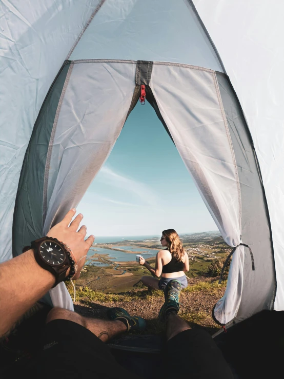 a man and a woman sitting inside of a tent, unsplash contest winner, inspiring birds eye vista view, instagram story, view(full body + zoomed out), over the hills