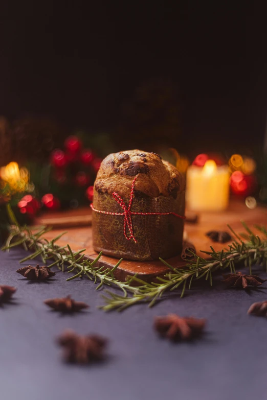a loaf of bread sitting on top of a wooden cutting board, festive, dark lit candles, profile image, wrapped