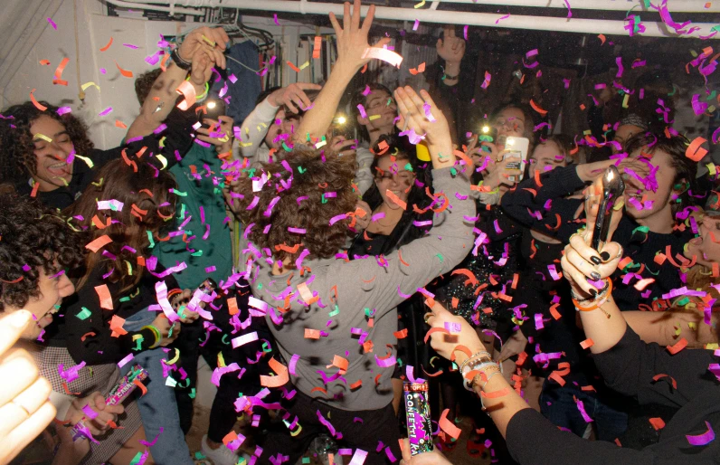 a group of people celebrating with confetti, a photo, happening, orelsan, on ship, adam ondra, underground party