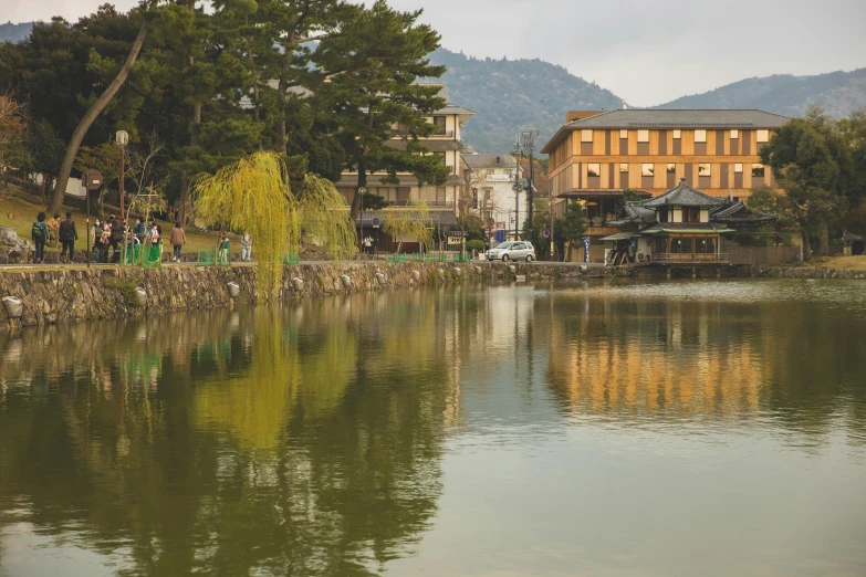 a body of water with a building in the background, inspired by Maruyama Ōkyo, unsplash contest winner, sōsaku hanga, japanese rural town, mirror lake, lachlan bailey, japanese town