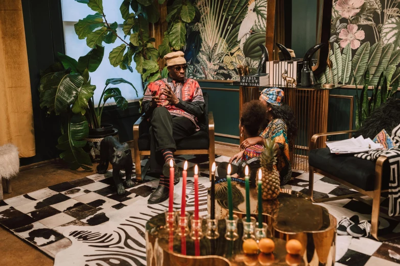 a group of people sitting around a living room, by Julia Pishtar, pexels contest winner, afrofuturism, holiday vibe, jungle around him, musician, thumbnail