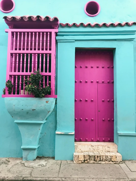 a blue building with a pink door and window, colombia, olive green and venetian red, ((pink)), magenta