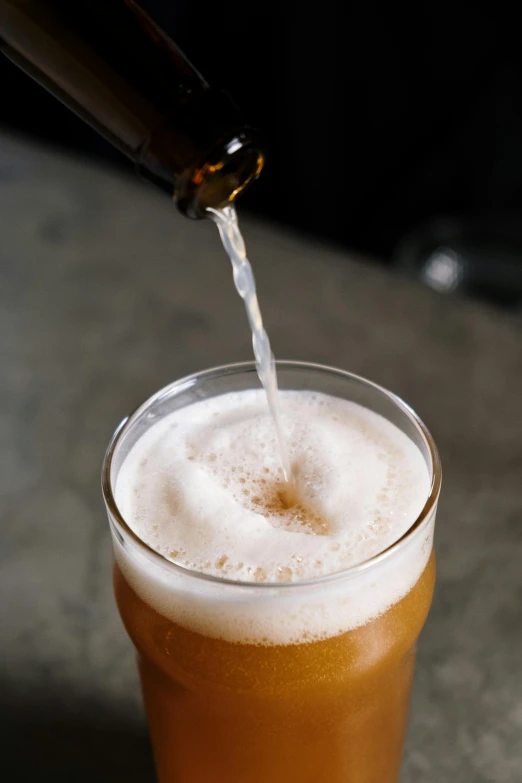a beer being poured into a glass, by Tuvia Beeri, unsplash, light brown, multiple stories, angle, vanilla