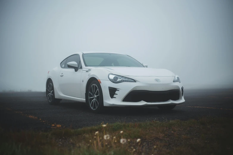 a white sports car parked on a foggy road, by Carey Morris, pexels contest winner, square, ae 8 6, frontal picture, extremely high resolution