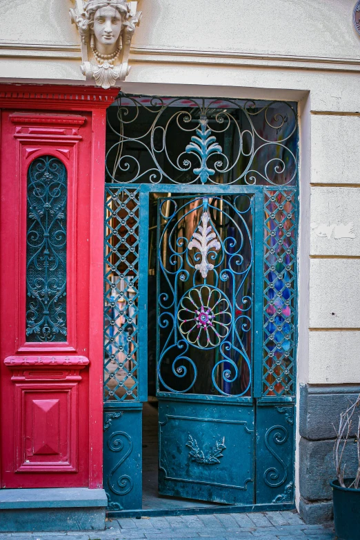 a couple of red and blue doors sitting next to each other, a photo, pexels contest winner, art nouveau, made of wrought iron, buenos aires, multicolor, square